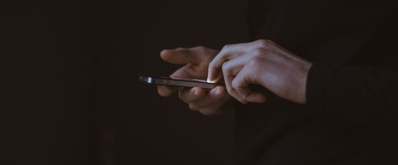 A person holding a cell phone in their hand