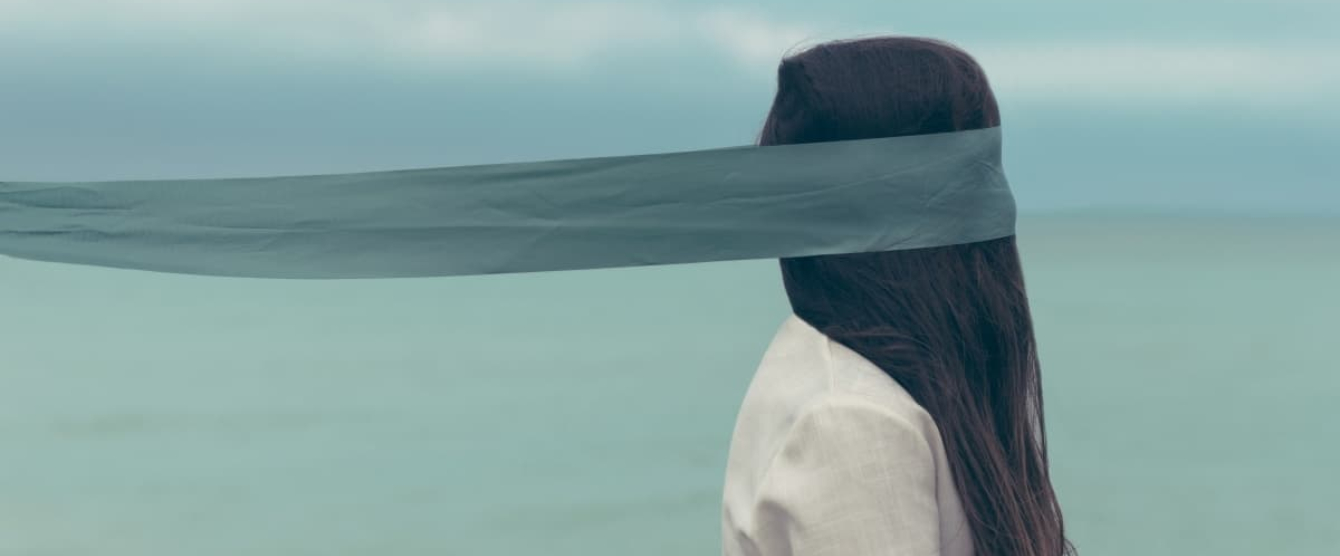 A person on the beach blindfolded