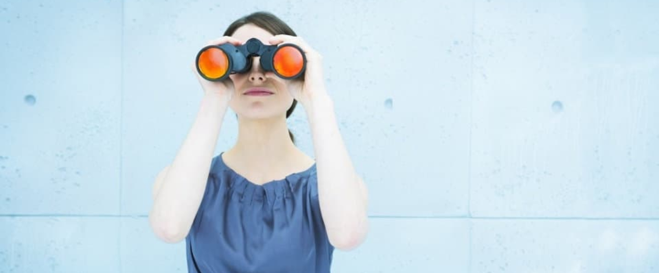 A woman looking through binoculars