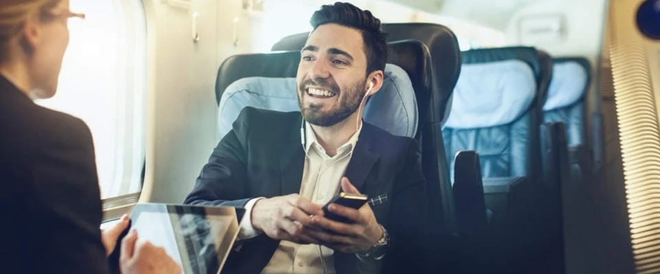 A man in a suit and tie looking at his cell phone