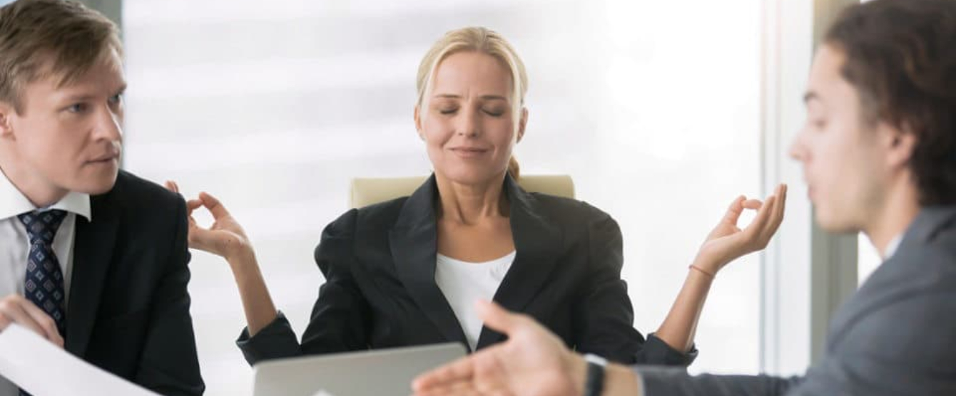 A woman in a white shirt and a man in a black shirt are using a laptop