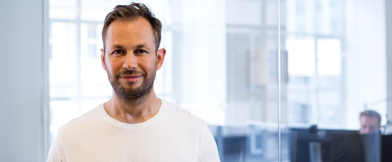 A picture of a man in a white shirt smiling