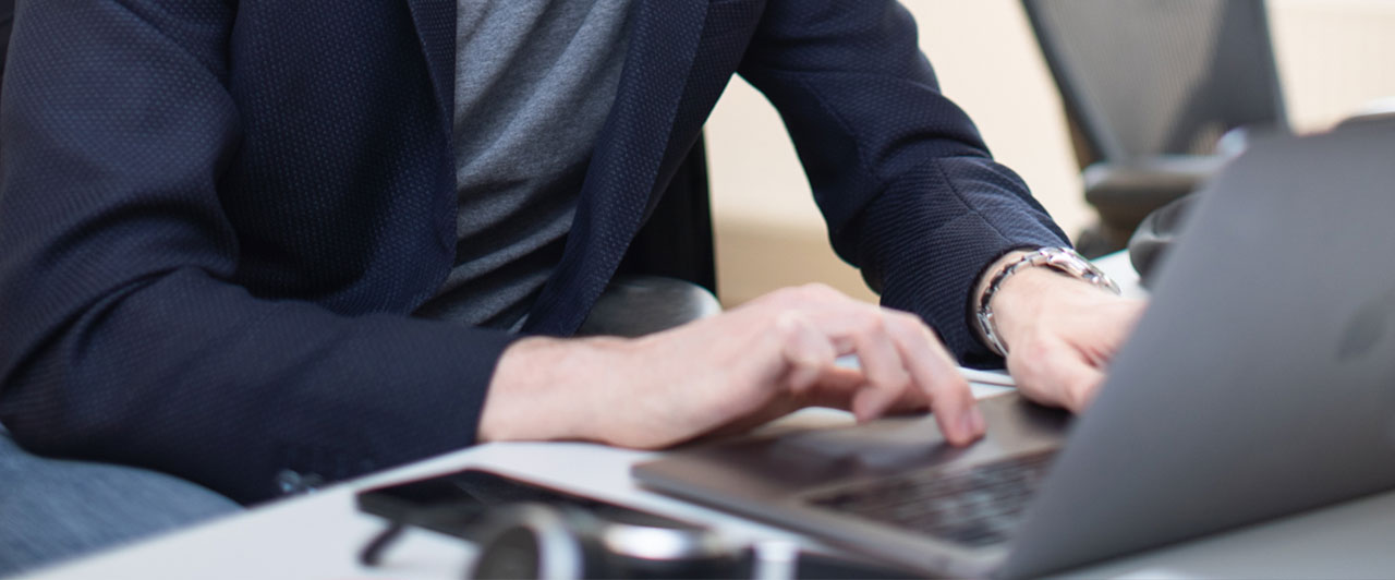 A man using a laptop computer on a table