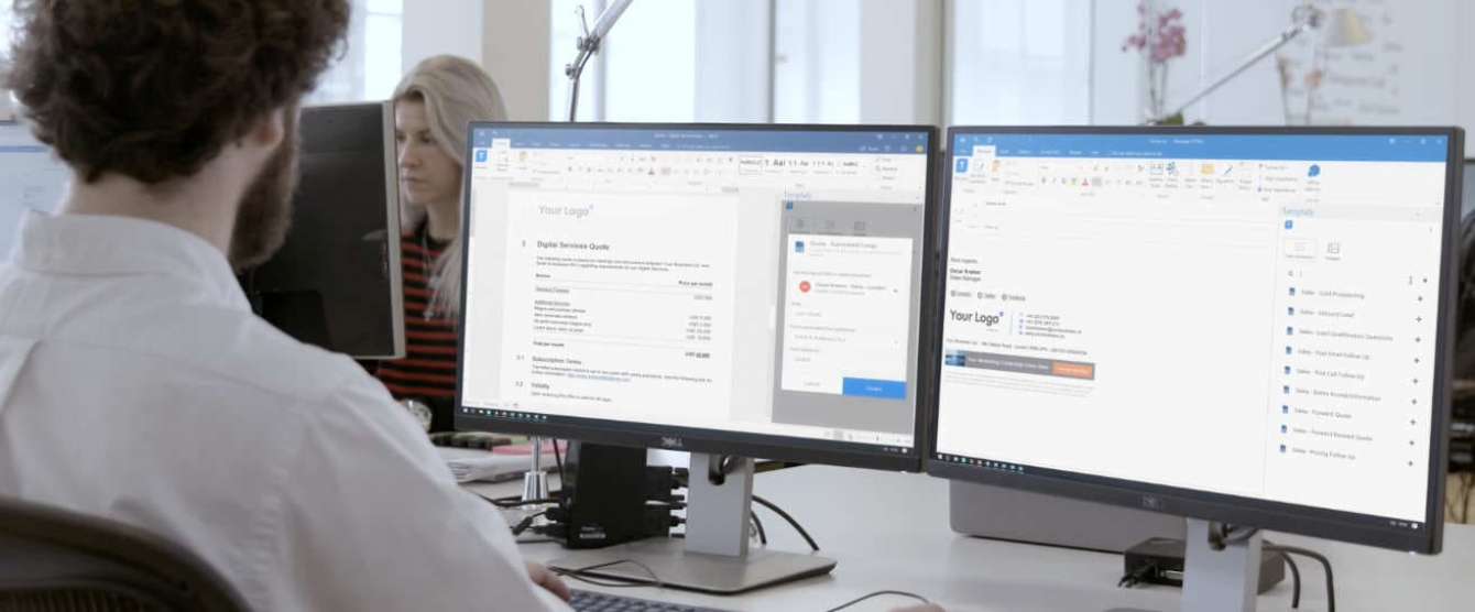 A man working on dual computer monitors