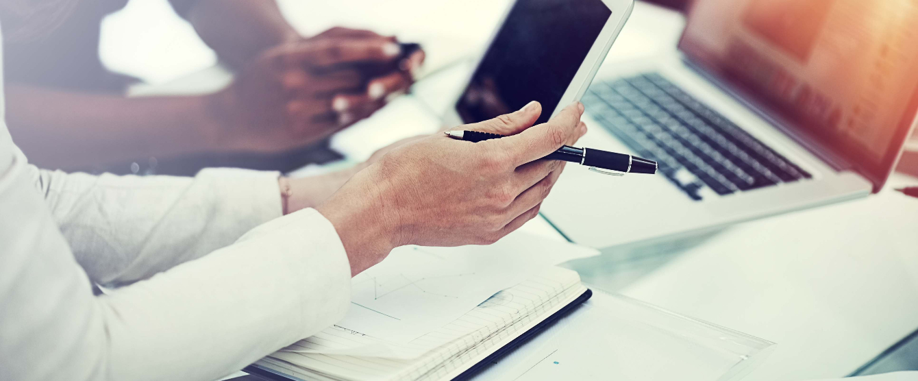 A person holding a tablet in their hand