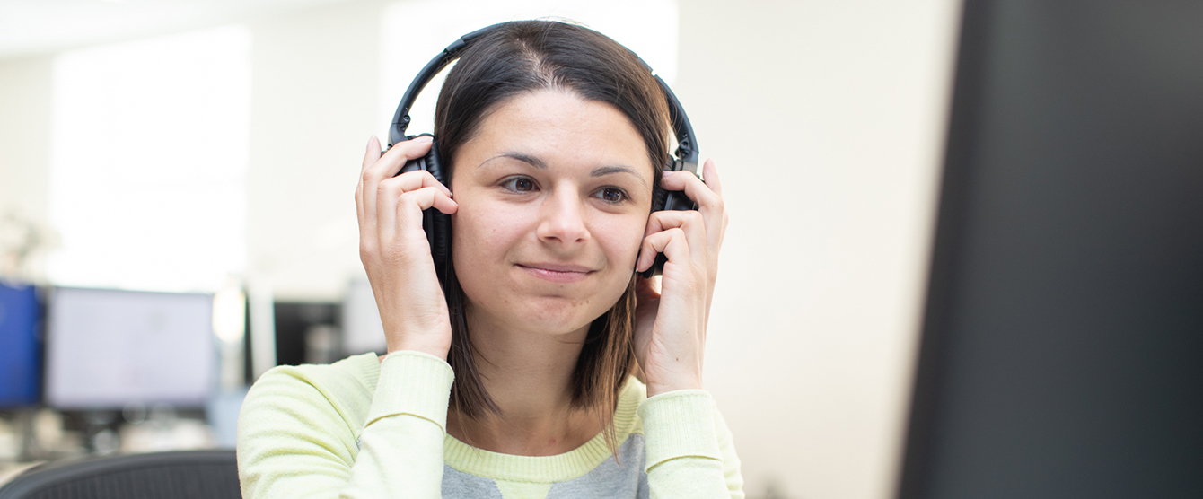 A woman with headphones on