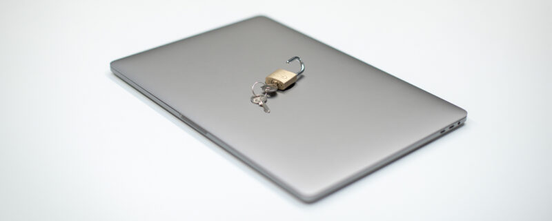 A laptop with a lock and key on top of it