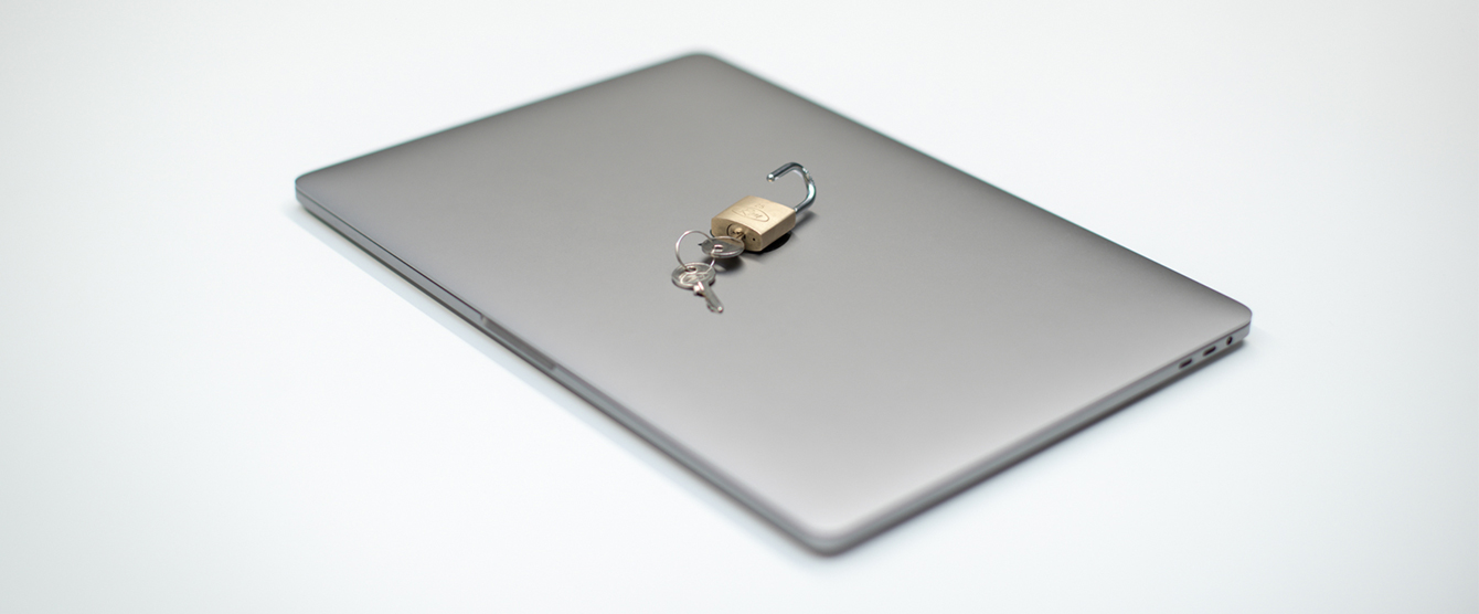 A laptop with a lock and key on top of it