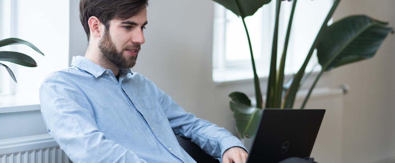 A man sitting in front of a laptop computer