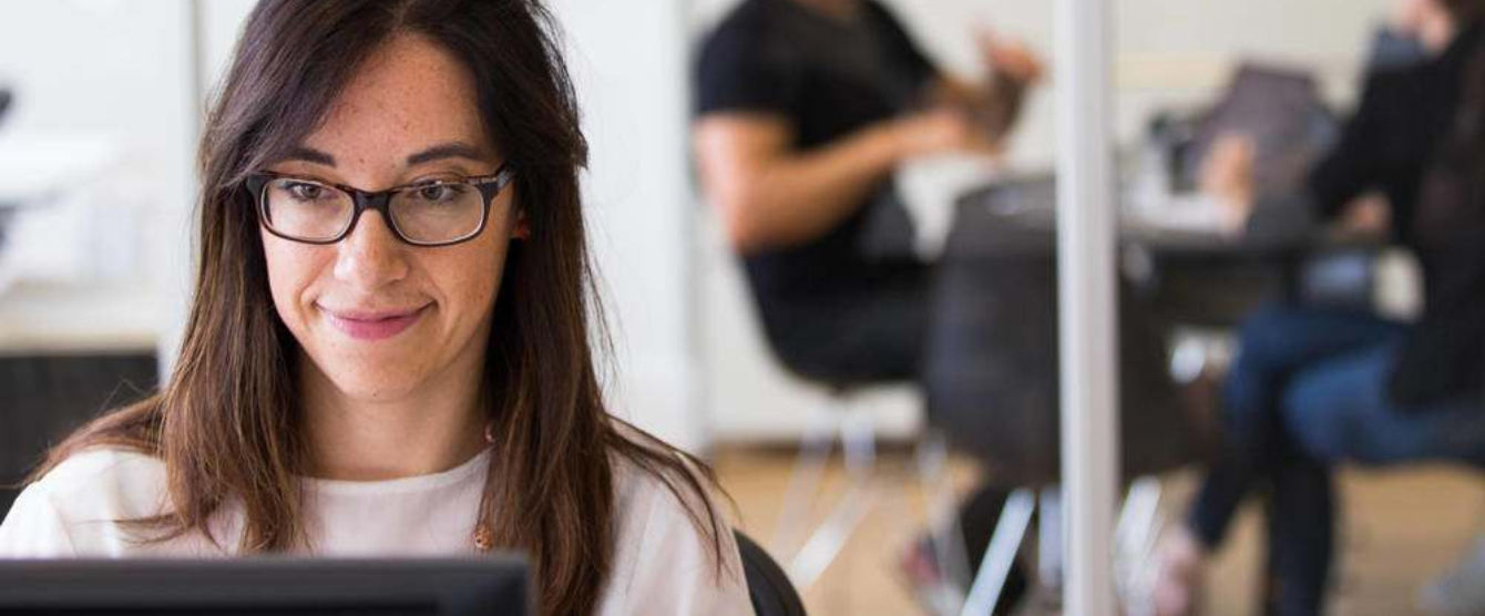 A woman sitting in front of a laptop