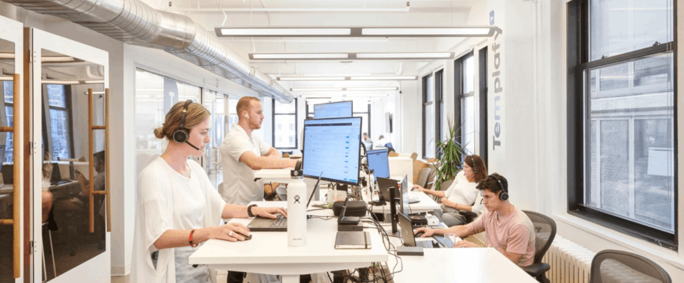 People working on computers in a large room