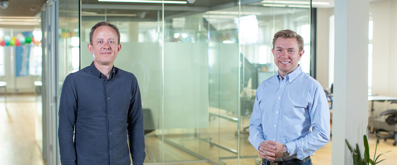 Two men standing around a business table