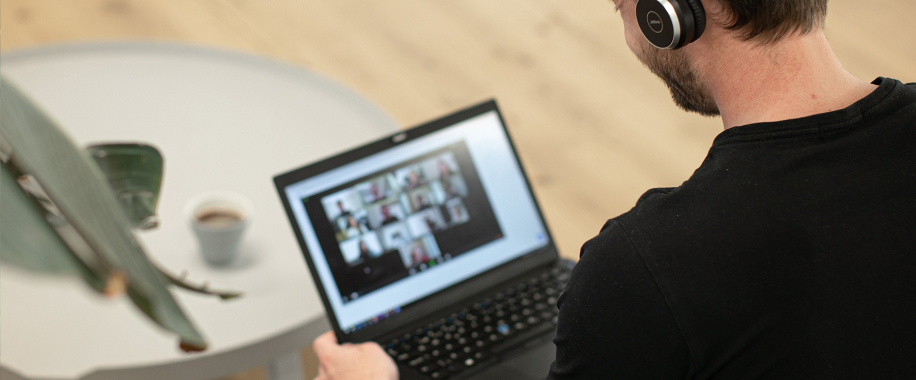 A man with headphones looking at his laptop